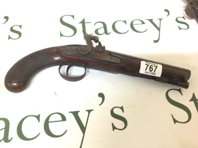 A 19th century Percussion pistol with an octagonal barrel cross hatched carved grip steel action with some engraving no obvious makers marks.