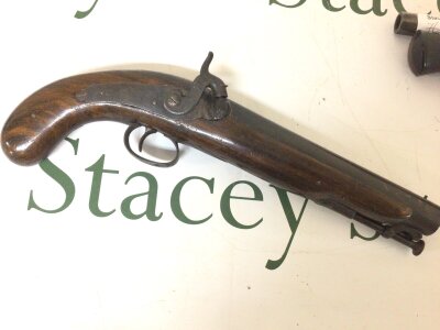 A 19th century Percussion pistol with full length walnut stock partially engraved trigger guard and action.no obvious marks or maker length 34cm