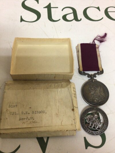 A George V For Long Service and Good Conduct Medal awarded to 3197 CPL GH Gibson with a numbers George V badge (2)