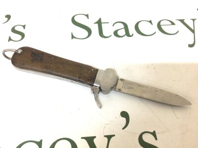 A German Third Reich Paratroopers gravitate knife the blade with makers stamp wooden grip and functional side retracting clip.