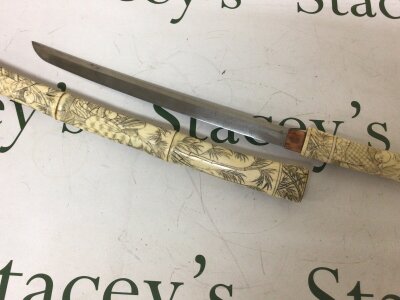 A Carved bone Japanese Antique Tanto sword the sectioned bone scabbard with carved figures and bamboo. Steel blade