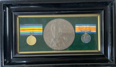 A framed WW1 pair of medals awarded to Arnold Binnie, King's Own Yorkshire Light Infantry with death plaque. K.I.A 21st July 1918 aged 19.