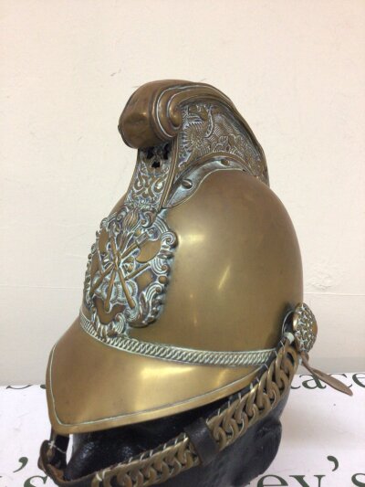 A Nice Example of a Victorian brass fireman’s helmet possibly replacement leather strap with original  brass fittings with original makers label Merryweather & Son Fireman’s outfitters London. Leather lining.