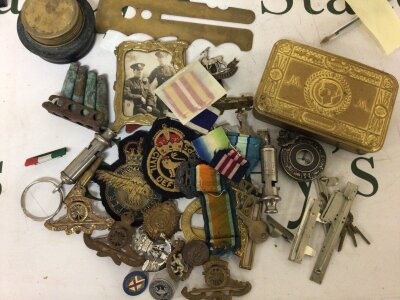 A collection of Military items including a I world war Christmas tin regimental cap badges medal ribbons whistles and other items.