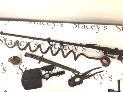 A collection of I world war Battlefield find relics including a section of a rifle bayonet a hand grenade converted to a table top lighter a pocket knife wire cutters spade head and a barbed wire ground screw.