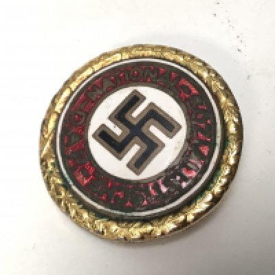 A Very interesting Gold Coloured Metal and enamel German NSDAP party badge given for continued unbroken membership.The 30mm badge has stamp marks Ges. Gesch Munchen9 and most significantly is numbered 32 this the type 2 badge. The earlier number reflects that it was most likely given to a High Leader. Hitler gave badge 7 to his Chancellor Dr Otto Meissner.