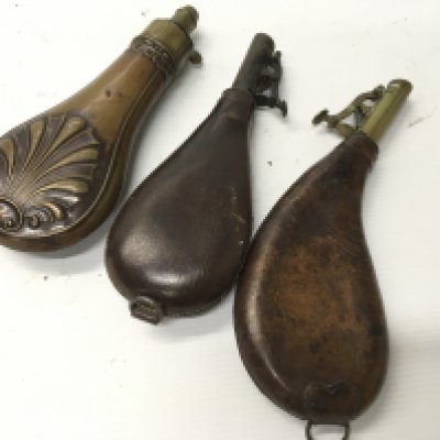 Two Antique leather and brass shot flasks and a copper powder flask (3)