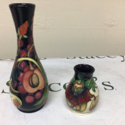 A Moorcroft vase decorated with pomegranate and other fruit and smaller Moorcroft vase. (2) No obvious damage vase height 21cm
