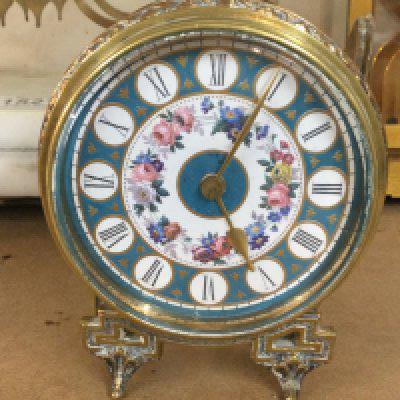 A French bedside clock the enamel dial with Roman numerals.- NO RESERVE