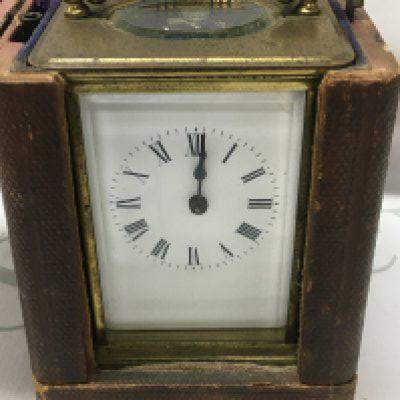 A brass cased carriage clock the enamel dial with Roman numerals. Fitted in original case .