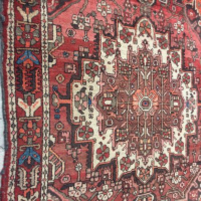 A Persian geometric rug on a red ground , 157 x 200 cm