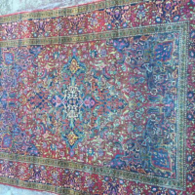 A. Persian rug with floral and geometric design. 195 x 135 cm .