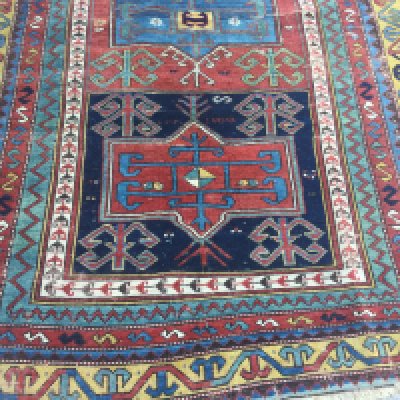 A Kazak rug with geometric centre and repeated pattern boarders. 225 x 140 cm .