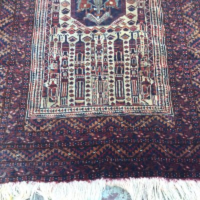 A Afghan rug with a central motif and repeated geometric boarders.170 x118 .