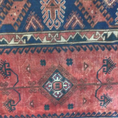 A Persian rug with geometric centre and boarder .190 x220 cm .