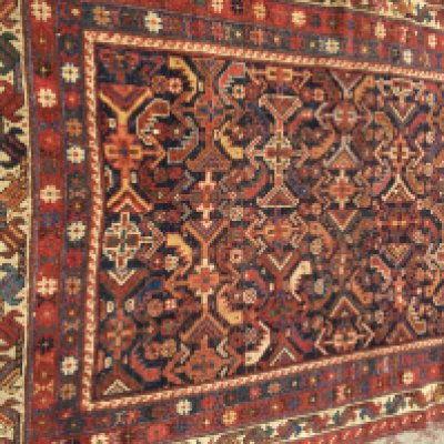 A Persian rug with geometric fields and repeated pattern boarder. 145 x 100 cm .