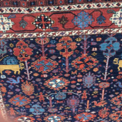 A Persian rug with geometric and animals field and floral boarder. 196 cm x 150 cm .