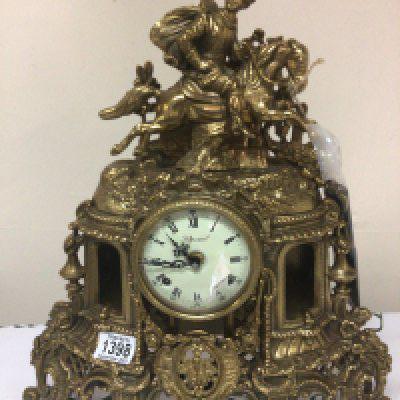 A brass cased Italian clock Imperial the case surmounted with a figure on a horse has key height 44cm.