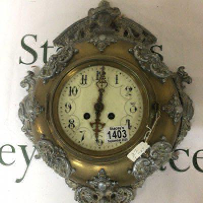 A brass and cast metal wall clock with an enamel dial for restoration. Diamter 33cm approximately.