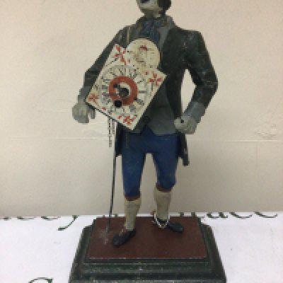 A Continental painted metal clock the peddler clock Height 40cm