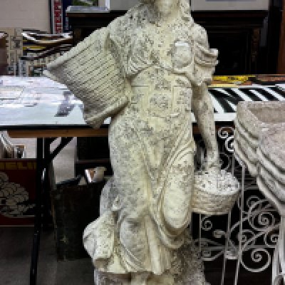 A large cast concrete garden statue of a maiden carrying a basket. 136cm.