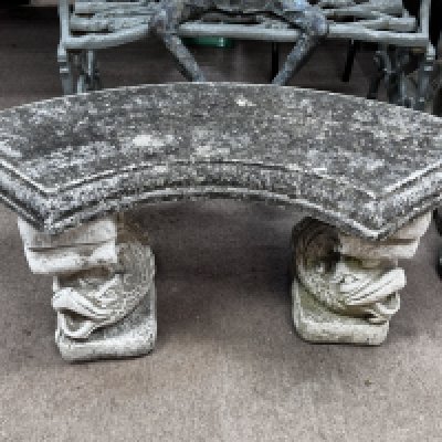 A cast concrete garden seat.