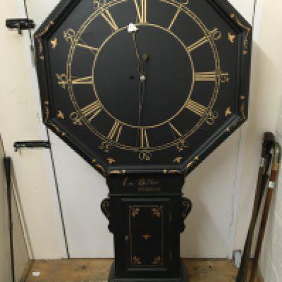A large Taven clock with painted case and octagonal dial with the inscription Eric Bullers Brixham fitted with a brass fusee movement with pendulum. The movement is an original the case later made copying the original case.