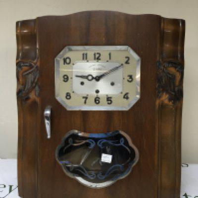 A Continental walnut cased Art Deco influenced wall clock with chrome mounts visible pendulum. The dial Veritable Westminster 2 Airs.