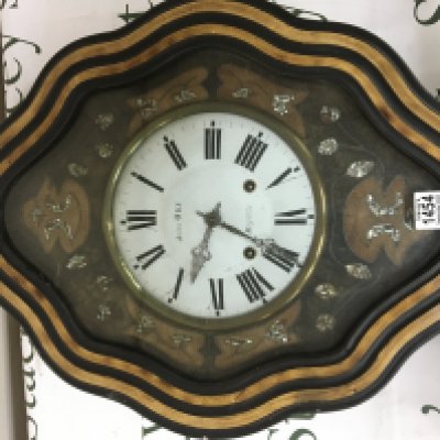 A Continental wall clock with mother of pearl inlay. The white enamel dial maker Jules Ory Mayenne.