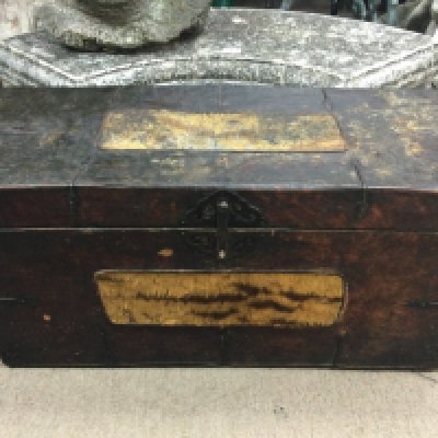An early 19th century chest banded in leather and tiger skin . Dimensions 35cm long 85cm wide 42Cm tall