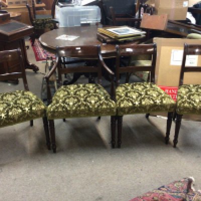 A set of twelve matching mahogany dining chairs including two carver chairs with inlaid backs green patterned upholstered seats and ring turned legs. This is a Harlequin set some chairs of the Period late George III with quality retrospective matching copys (10)