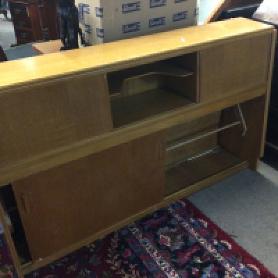 A mid 20th century cabinet with sliding doors. Length 143cm