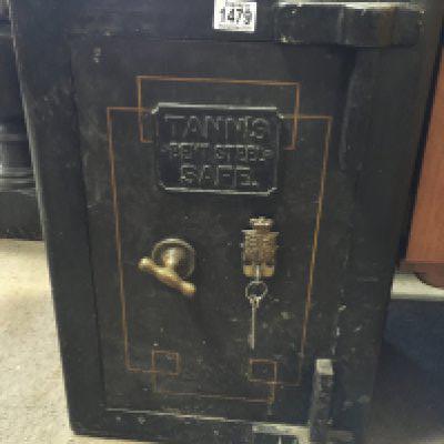 A Tanns bent steel Safe with key approximately 80cm tall 40cm wide