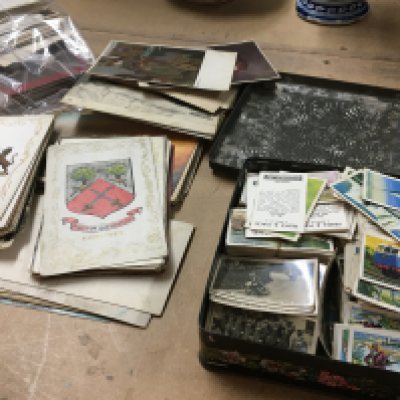 A collection of post cards and a collection of cigarettes .