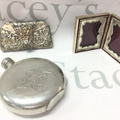 A small silver plate round hip flask decorated with two racehorses and a small heavy double photo frame embossed and a silver plated hanging item. Postage category B- NO RESERVE