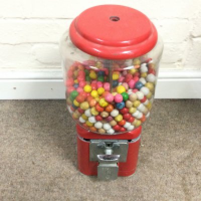 A vintage American coin op bubble gum machine. Approximately 43 cm by 16cm,