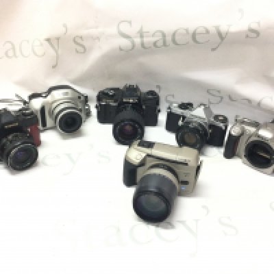 Six vintage cameras including Nikon, Konica, Pentax, Minolta . Postage category c