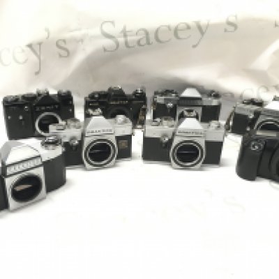 8 SLR cameras including Praktica, canon etc . Postage category C