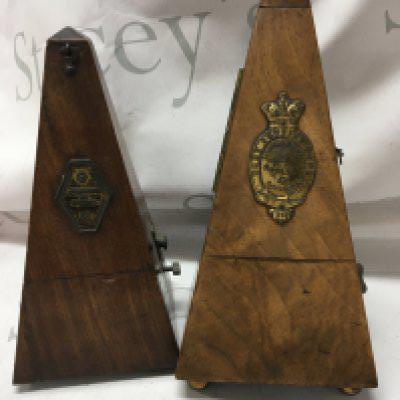 Two walnut cased metronomes .