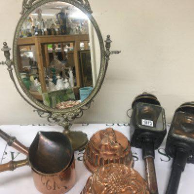 A pair of 19th century coaching lamps a brass mirror copper jelly moulds and copper cooking pots.