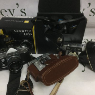 A collection of various cameras and photographic equipment including a Nikon Coolpix L830, Pentax examples and others. Shipping category D.