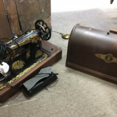 A cased Singer sewing machine and a letter rack. This lot cannot be posted