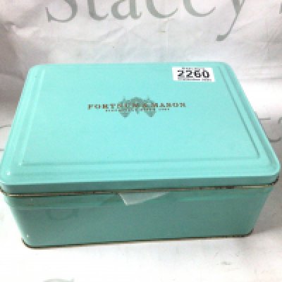 A vintage fortnum and mason tin filled with antique lighters and some accessories.