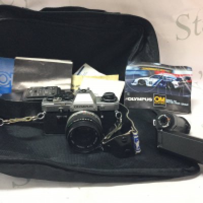 A vintage Olympus OM10 camera with accessories . Postage category B