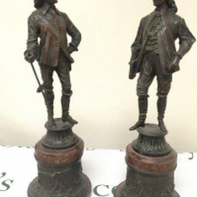 A pair of Spelter figures in 17th century style dress on simulated marble bases (2)- NO RESERVE