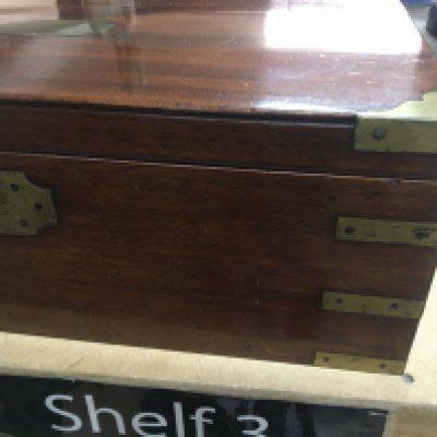 A Mahogany campaign writing slope brass bound with a fitted interior.