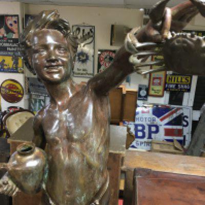 A large bronze in the manor of Giovanni De Martino figure of a boy holding a crab 115 cm .