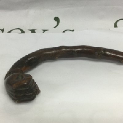 A walking cane, the handle in the form of a clenched fist, approx total length 80cm. Shipping category D.