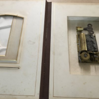 A Victorian photo Album inset with a music box .