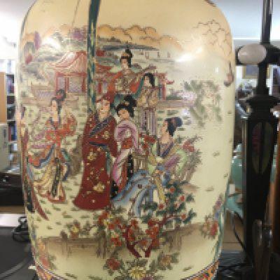 A large satsuma style vase decorated with figures in a landscape view .